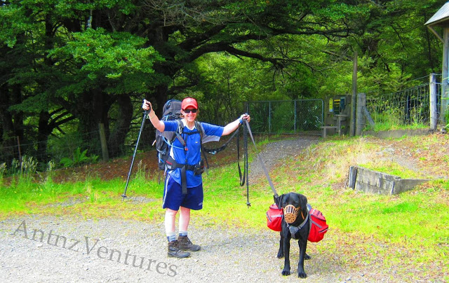 Antnz (left) and ADNZ Ben with a muzzle on. Antnz has her arms raised in celebration, ADNZ Ben has a basket muzzle on.