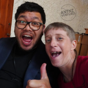 Selfie of Jade Farrar (left) and Antnz (right). Both Jade and Antnz have goofy faces and Jade has his thumb up in mid-frame foreground.