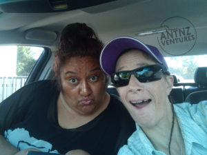 Wairemana Campbell on left making a "ducky face", Antnz on right with a goofy smile. They are in the front seat of a car.