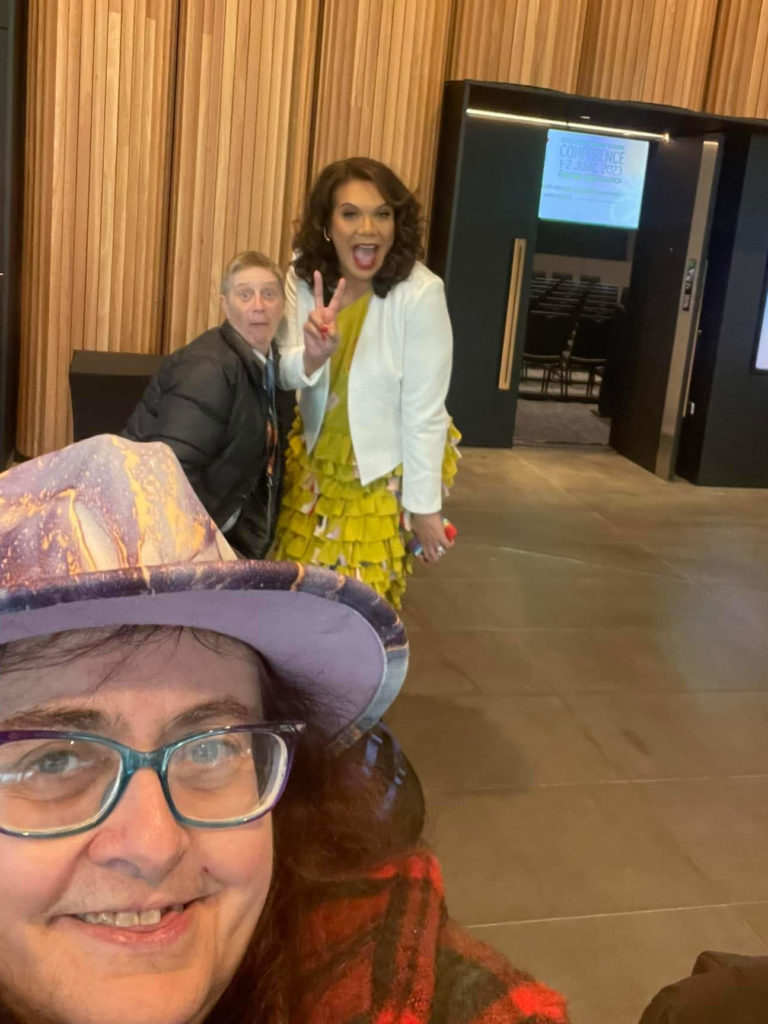 A selfie of Ann-Marie in a funky hat, Antnz and Mary Haddock-Stanliard in the background pulling faces